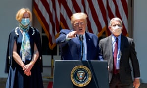 Donald Trump is flanked by Dr Deborah Birx and Dr Anthony Fauci at the White House coronavirus taskforce briefing on Friday.