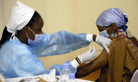 A medical student in Kigali, Rwanda administers a Covid vaccine.