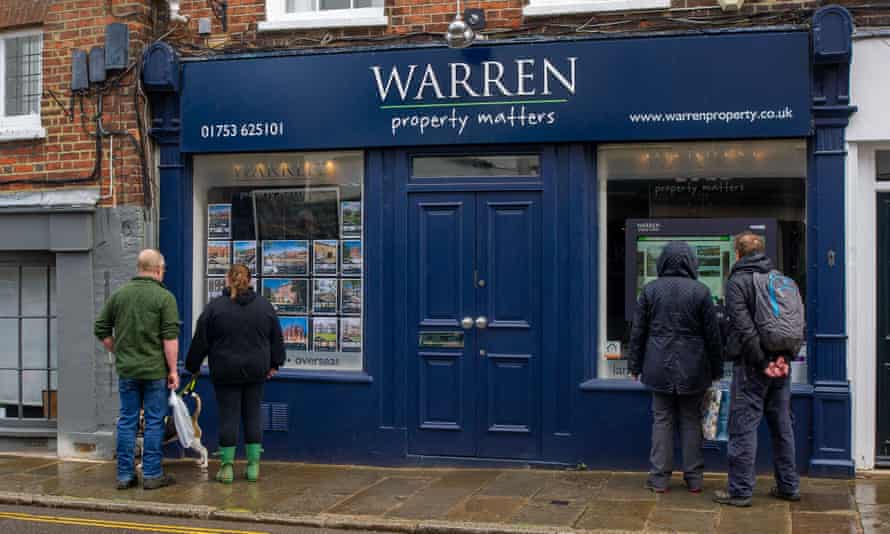 People look at properties in an estate agent’s window in Eton, Windsor, England.