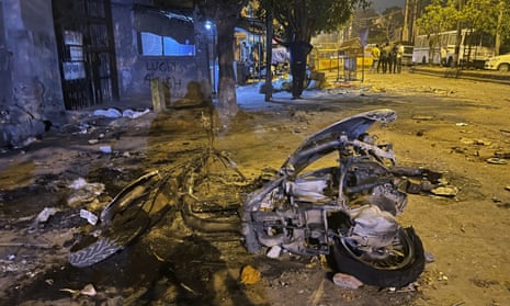 The remains of a motorcycle lie in a street after communal violence in Delhi on Sunday.