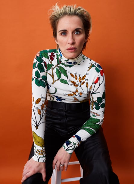 Actor Vicky McClure, in floral top and dark trousers, against orange background, November 2021