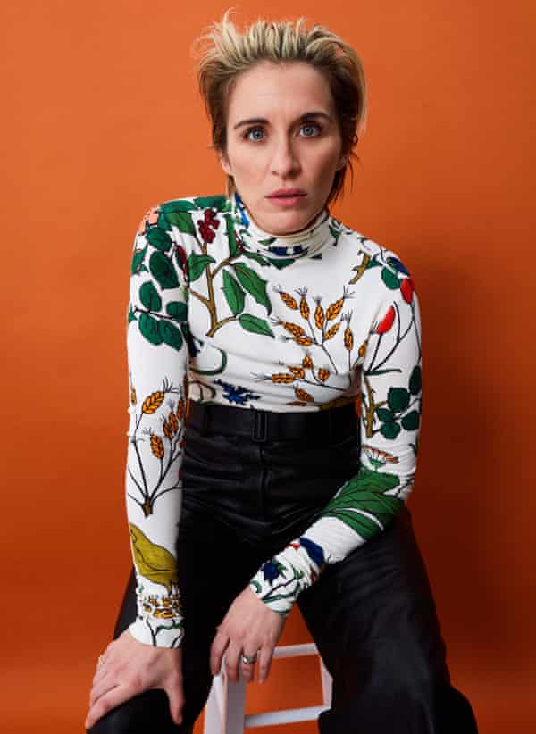 Actor Vicky McClure, in floral top and dark trousers, against orange background, November 2021