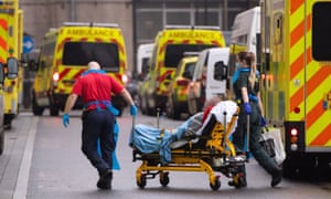 Paramedics unloading a patient today from an ambulance outside the Royal London Hospital in London.