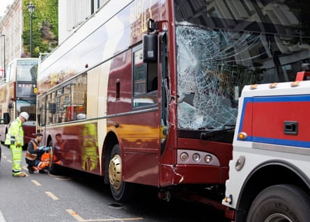 A doubledecker tour bus with a smashed windscreen