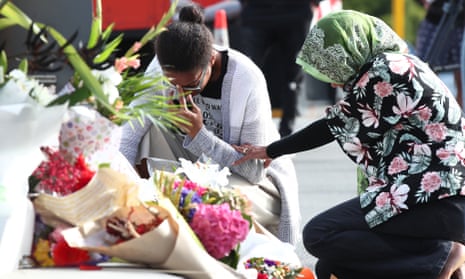 Locals lay flowers in tribute to those killed and injured at Deans Avenue near the Al Noor Mosque on March 16, 2019 in Christchurch, New Zealand.