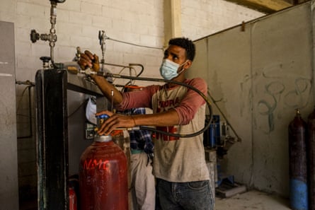 A staff member refills an oxygen cylinder at Gast Solar Mechanics in Addis Ababa, Ethiopia