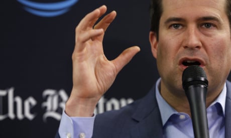 Head and shoulders of Seth Moulton speaking during an interview in Boston in 2017, speaking into a microphone with his right hand raised to express himself