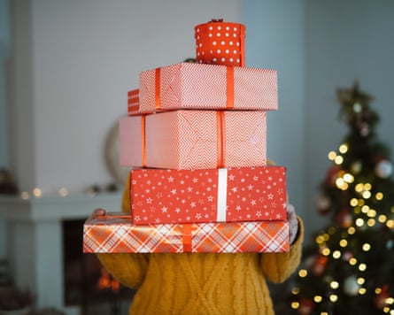 Woman holding pile of Christmas presents