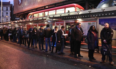 Commuters queue at Victoria bus station during a tube strike on 9 January