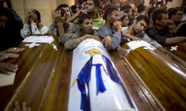 Relatives of Coptic Christians who were killed during a bus attack, surround their coffins, during their funeral service, at Abu Garnous Cathedral in Minya, Egypt.