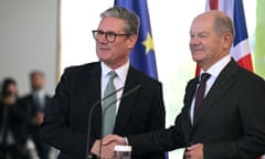 German Chancellor Olaf Scholz (right) and Britain's Prime Minister Keir Starmer shake hands at the end of a joint press conference in Berlin.