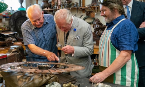 Charles examines fine engraving as he chats to artisans at the Copper Works at Newlyn Harbour near Penzance in July this year.