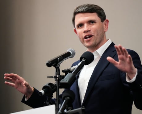 a man speaks into a set of microphones