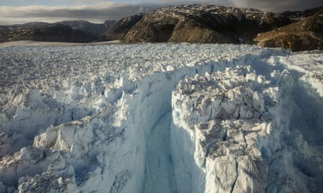A large crevasse forms in the Helheim glacier in Greenland, as it collapses in to the sea.