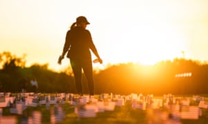 Supporters of the Covid Memorial Project place 20,000 American flags on the National Mall as the US coronavirus death toll approaches 200,000 lives lost to date.