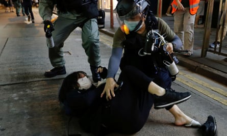 Riot police detain a pro-democracy demonstrator in Hong Kong