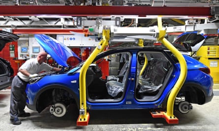 A man helps assemble an Opel Grandland X SUV car at Opel’s plant in Eisenach, eastern Germany.