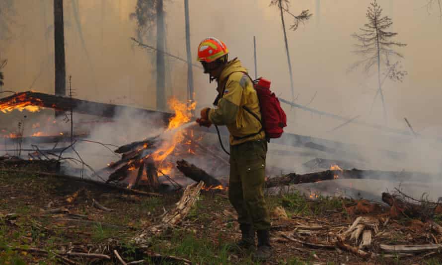 A firefighter battles a forest fire in Yakutia.