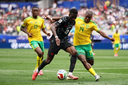 Mbekezeli Mbokazi defends against a Canada player.