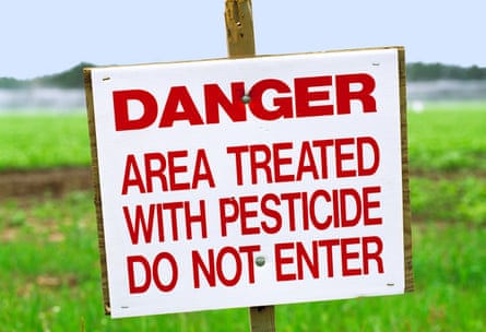 a sign reads ‘danger area treated with pesticide do not enter’