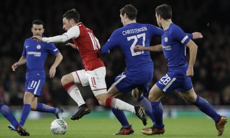 A surging Mesut Ozil is caught by Chelsea’s Andreas Christensen.