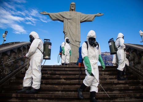 Soldiers of the Brazilian army disinfect the Cristo Redentor monument in Rio de Janeiro to reopen the tourist spot to the public on 15 August.
