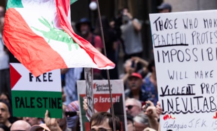 People gather at Town Hall in the Sydney CBD to protest Isaac Herzog's visit to Australia.