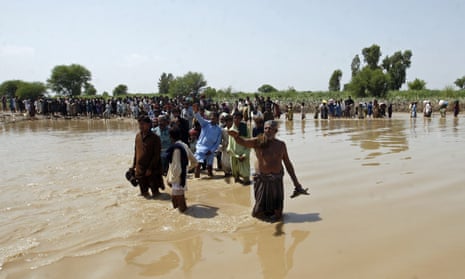 People affected by unprecedented flooding wait for relief aid in the Ghotki district of Sindh province, Pakistan.