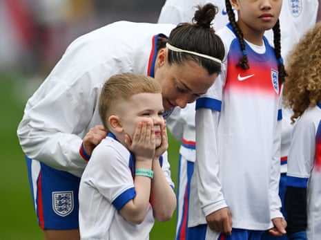 Lucy Bronze of England with an excited mascot during the national anthems.