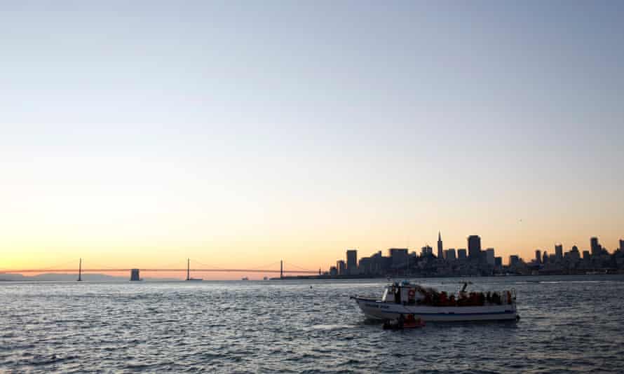 Swimmers with the South End Rowing Club prepare to jump into San Francisco Bay near Alcatraz Island during the annual New Year’s Day swim to Aquatic Park in San Francisco, California, US.