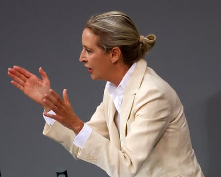 A woman gestures emphatically as she gives a speech