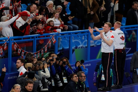 Canada's players and fans celebrate their victory during the men's curling gold medal match between Canada and Great Britain.