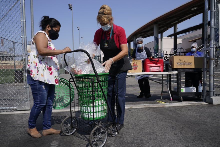 women look into cart with bag inside