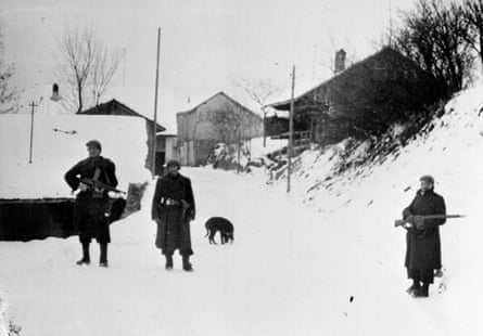 Militiamen patrolling in a mountain village in Haute-Savoie suspected to shelter Resistance fighters on 24 February 1944.