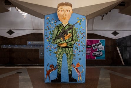 Blooms not bullets … mural showing a soldier with flowers bursting out of his rifle, coloured in by a young boy called Oleksii.