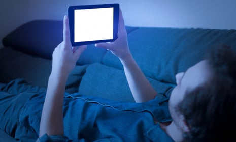Man looking at blue light on a phone screen