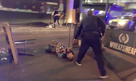 A picture that has been circulating showing a man on the ground; he appears to have canisters strapped to his body. The Guardian is not showing his face until his identity and connection to the incident has been established.