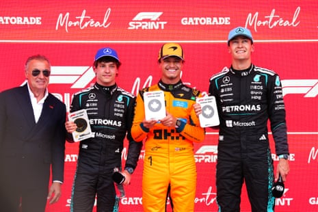 Jean Alesi, with Kimi Antonelli, Lando Norris and George Russell as they hold their prizes.