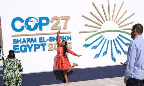 A woman poses in front of the congress centre staging Cop27 at the end of the first week of the summit in Sharm el-Sheikh.