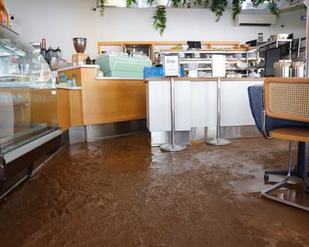 Brown water on the floor of a commercial kitchen.