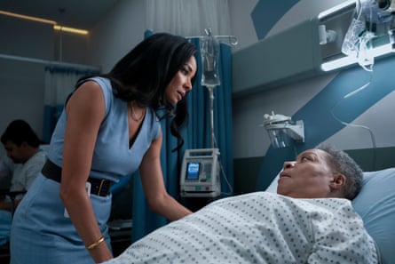 Rochelle Aytes is standing talking to Juanita Jennings, who is lying in a hospital bed.