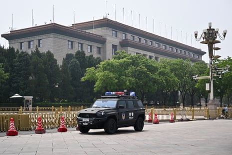A police vehicle parked near the Great Hall of the People.