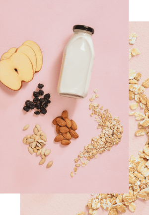 Milk bottle surrounded by nuts and fruit