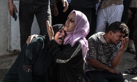 Distraught relatives of Palestinians killed in Israeli airstrikes mourn in Gaza City.