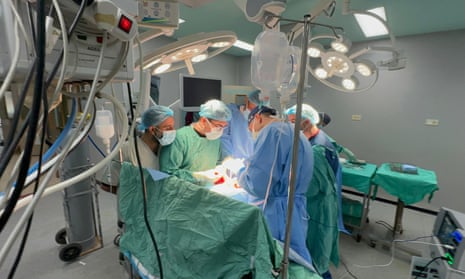 Doctors in the European hospital wearing masks and gowns as they carry out surgery.
