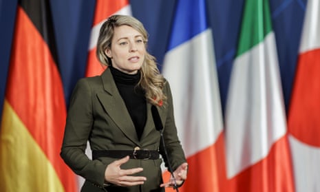Mélanie Joly in front of international flags