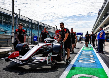 Haas team members working with their car in Miami