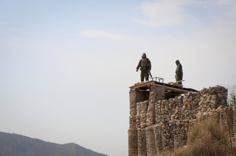 Two soldier stood at their post on top of a hill.