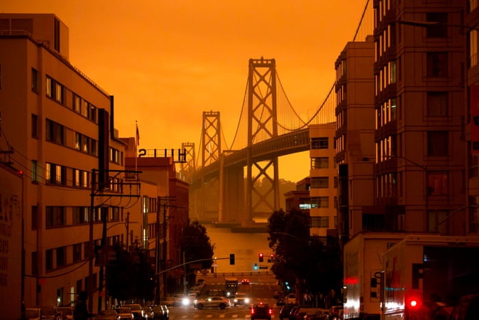The San Francisco Bay Bridge is seen under an orange smoke-filled sky.
Photograph: Brittany Hosea-Small/AFP/Getty Image