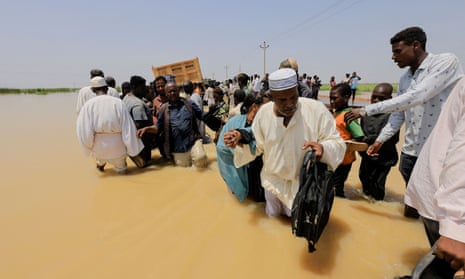 People attempt to find dry ground during a flood in Gezira state, Sudan, August 2022.